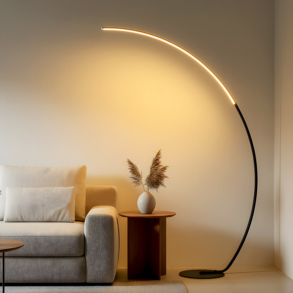 Modern living room with a curved floor lamp, sofa, and side table.