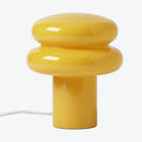 Yellow table lamp with a unique design on a white background