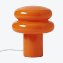 Orange table lamp with a unique design on a white background