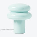 Light blue ceramic table lamp on a white background