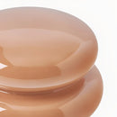Close-up of a peach-colored ceramic plate on a white background