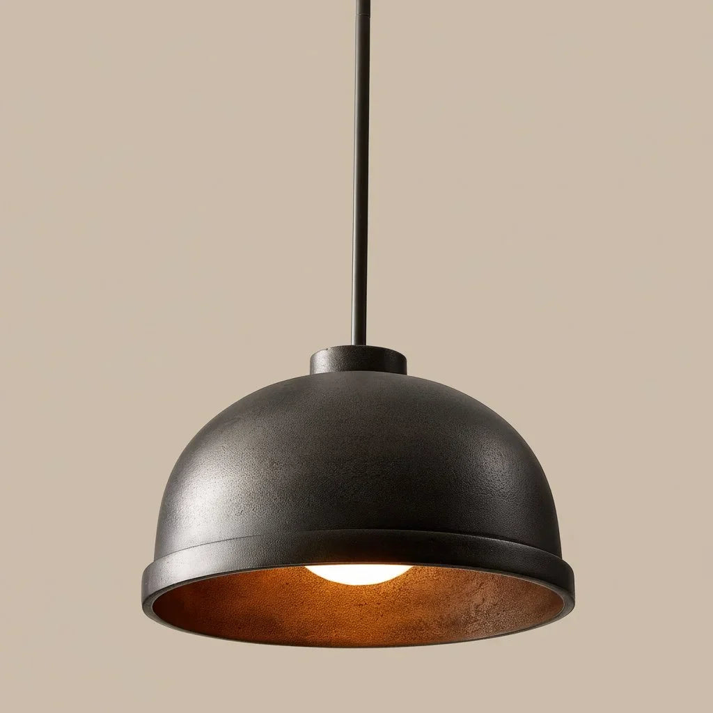 Black pendant light with a warm glow on a beige background