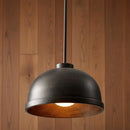 Black pendant light against a wooden background