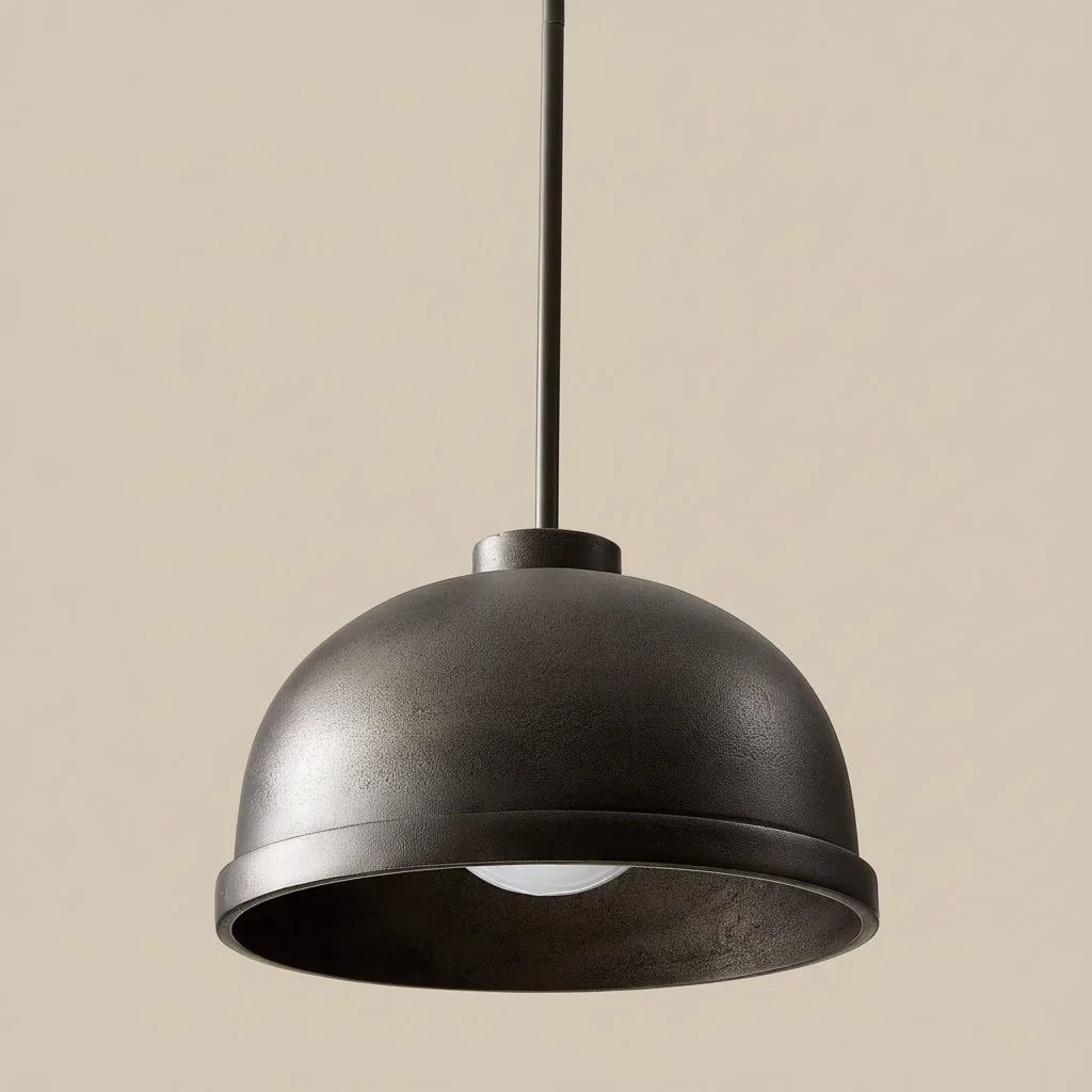 Black pendant light against a beige background