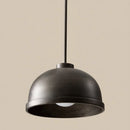 Black pendant light against a beige background