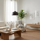 Modern living room with white sofa, armchair, wooden coffee table, and decorative elements.