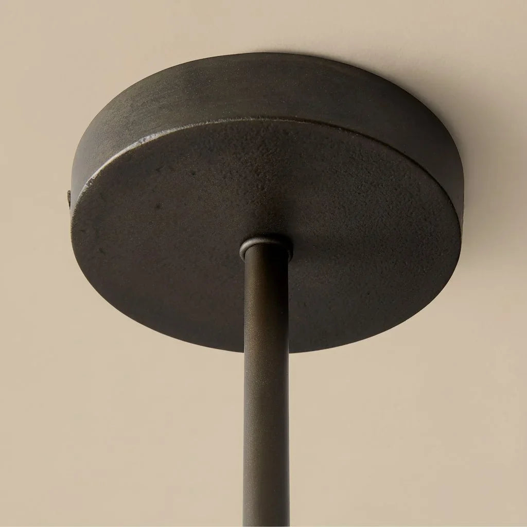 Ceiling light fixture with dark finish on a beige background