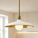 Pendant light with gold frame and white shade in a room setting