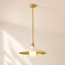 A modern pendant light fixture with a brushed gold metal frame and a wide, shallow white glass shade, suspended from a matching gold ceiling canopy against a warm beige wall.