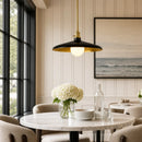 Modern dining room with marble table, pendant light, and decorative elements.