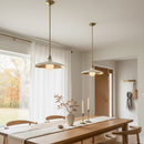 Dining room with wooden table, chairs, and pendant lights.