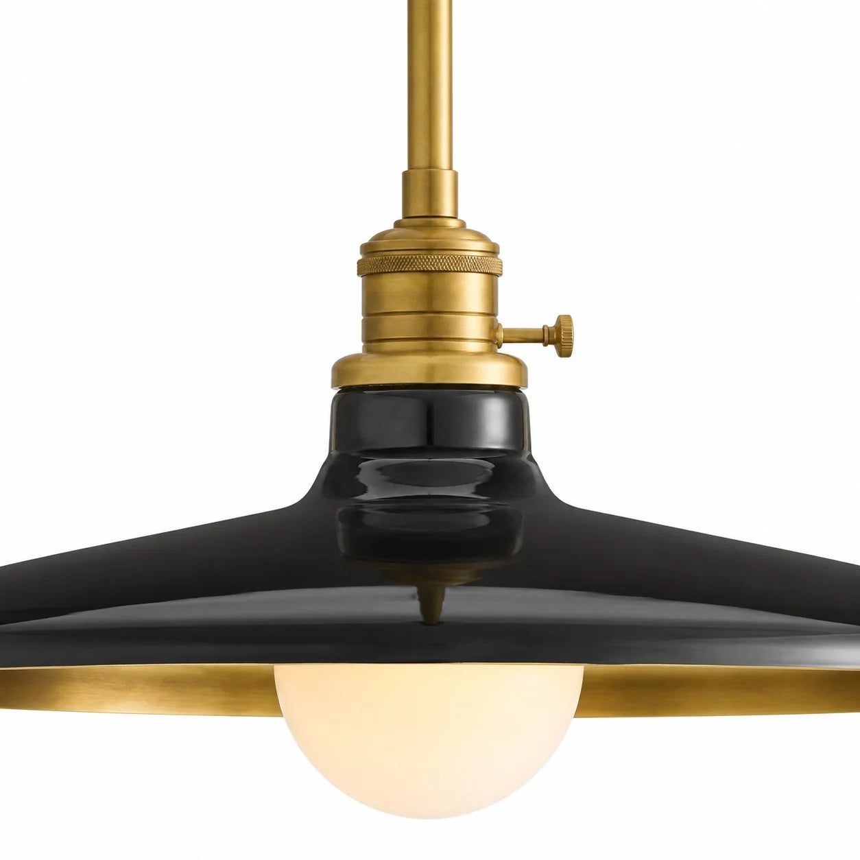 Black pendant light with brass accents on a white background