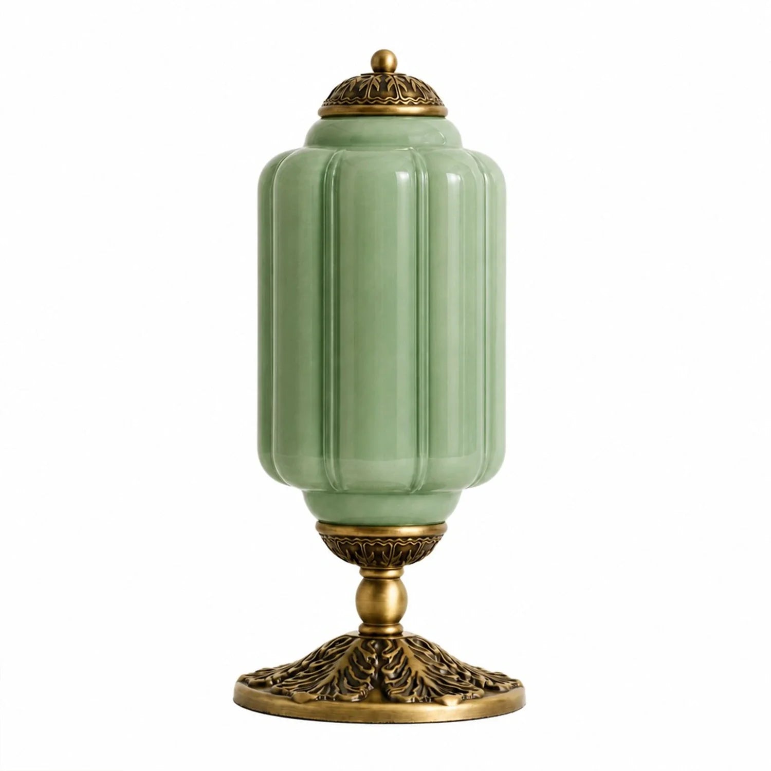 Decorative lamp with green glass and gold metal base on a white background