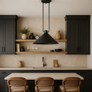 Modern kitchen with black pendant light, wooden shelves, and black cabinets.