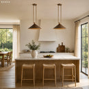 Modern kitchen with pendant lights, island, and stools.