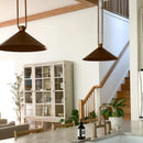 Modern kitchen with pendant lights, a staircase, and a dining area.