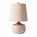 Table lamp with a beige fabric shade and ceramic base on a white background