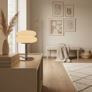 Modern interior design with a lamp, books, and decorative items in a room.