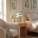 Modern living room with a beige sofa, armchair, and decorative lamp.