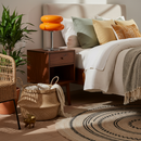 Cozy bedroom with a bed, nightstand, and decorative items.