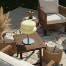 Outdoor patio setting with wicker furniture, table, and decorative items.