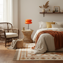 Cozy bedroom with a bed, chair, and side table.