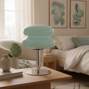 Modern light blue stool on a wooden table in a living room setting
