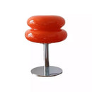 Red bar stool with a chrome base on a white background