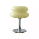 Modern stool with a cream-colored top and chrome base on a white background