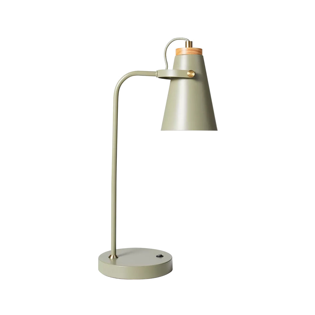 Green table lamp with a wooden accent on a white background