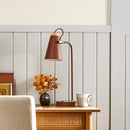 Decorative lamp on a wooden surface with a light-colored wall background