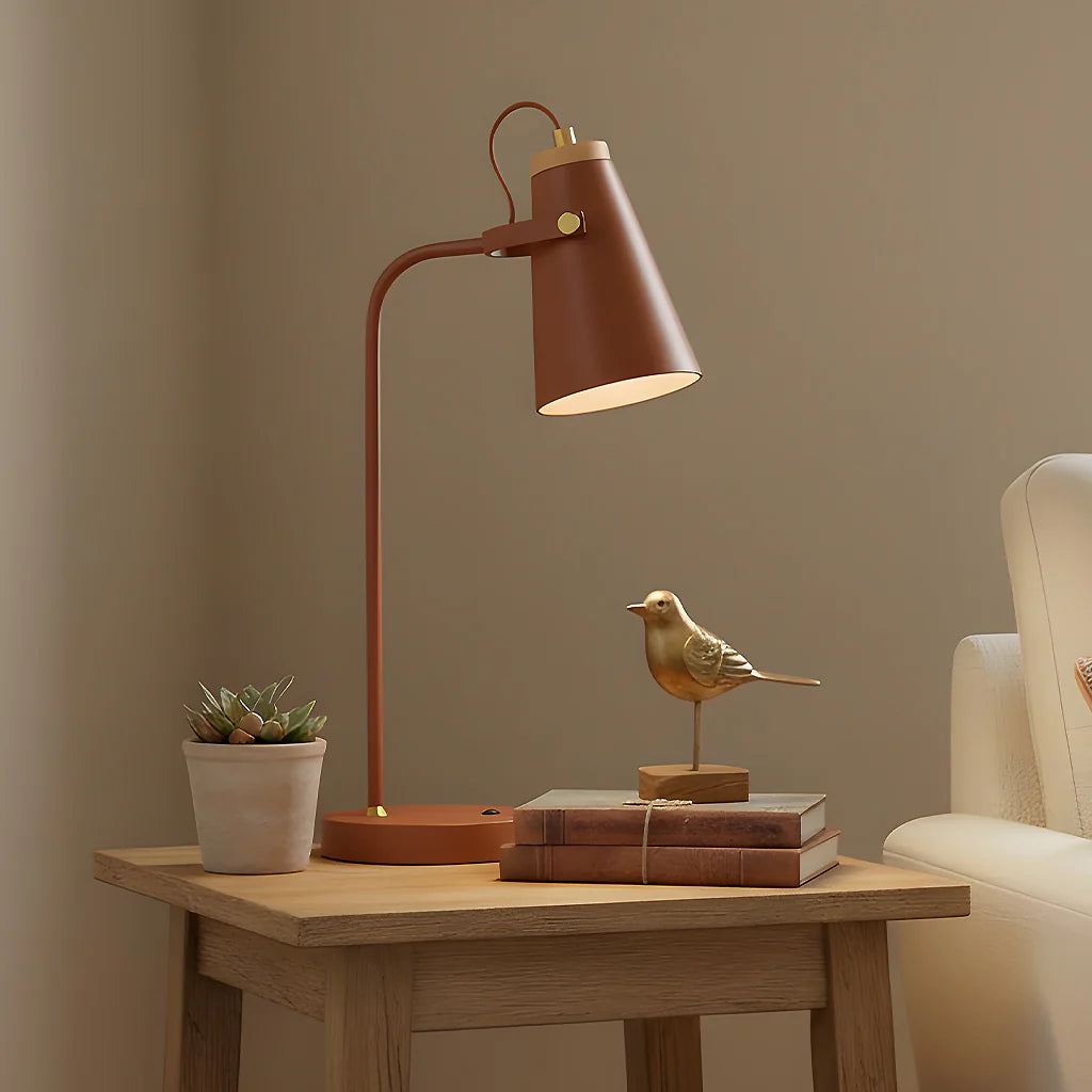 Brown table lamp on a wooden side table with decorative items against a beige wall.