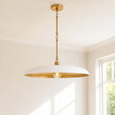 A modern pendant light fixture with a wide white dome shade and a brushed gold metal frame, hanging from a gold ceiling canopy in a bright room.