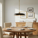 Dining room with wooden table, chairs, and a pendant light.