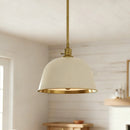 Pendant light with white shade and gold trim hanging in a room.
