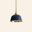 Pendant light with navy blue shade and gold trim on a beige background
