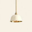 Pendant light with white shade and gold metal accents on a beige background