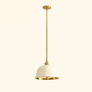 Pendant light with gold finish and white shade on a beige background