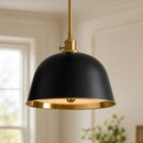 Black pendant light with gold interior in a room setting