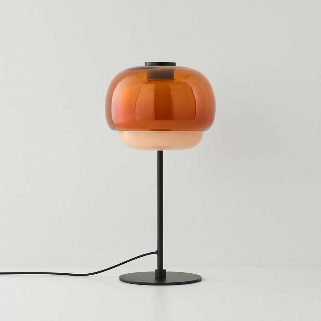 Table lamp with orange glass shade and black base on a white background