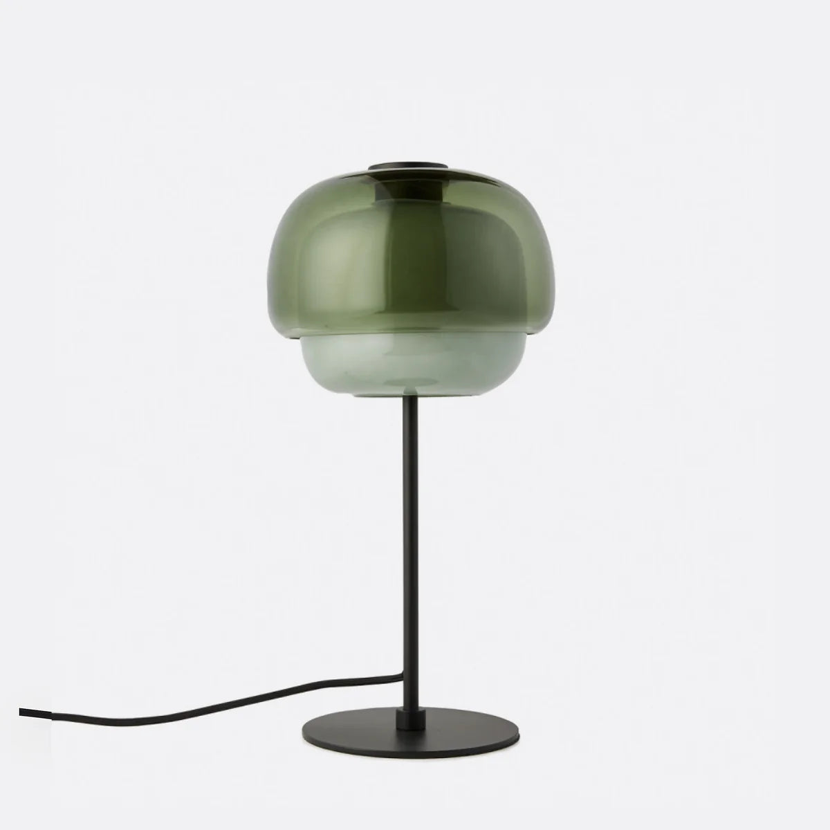 Green table lamp with a black base on a white background