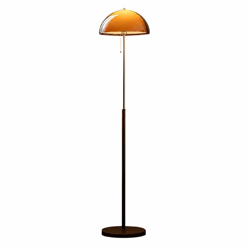 Floor lamp with a yellow glass shade on a white background