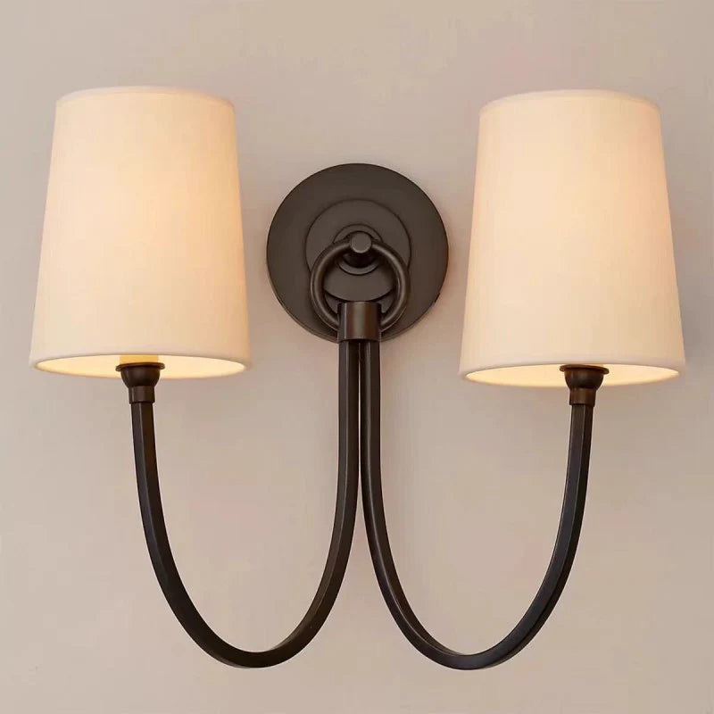 Wall sconce with two lamps on a plain wall