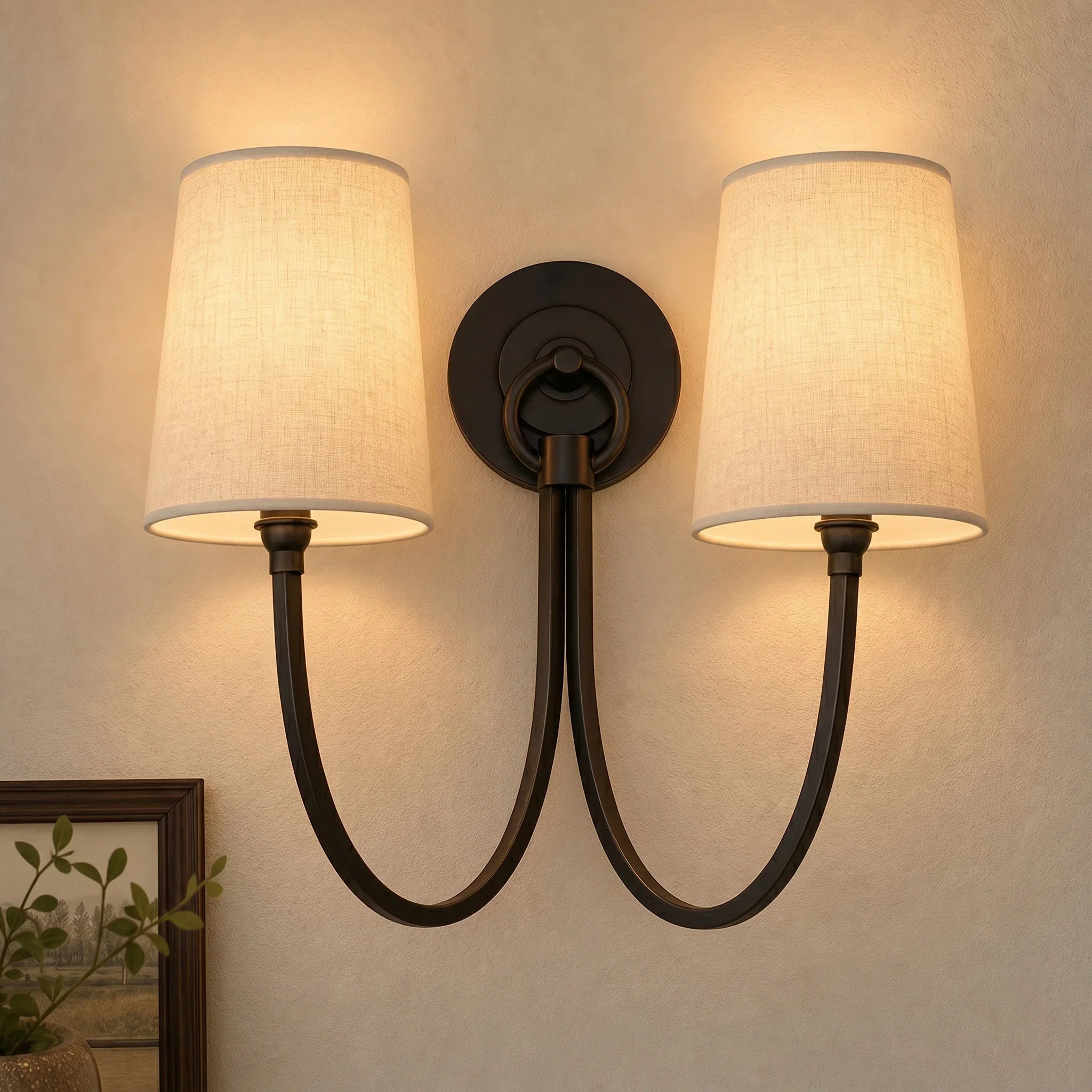 Double wall sconce with fabric shades on a beige wall.