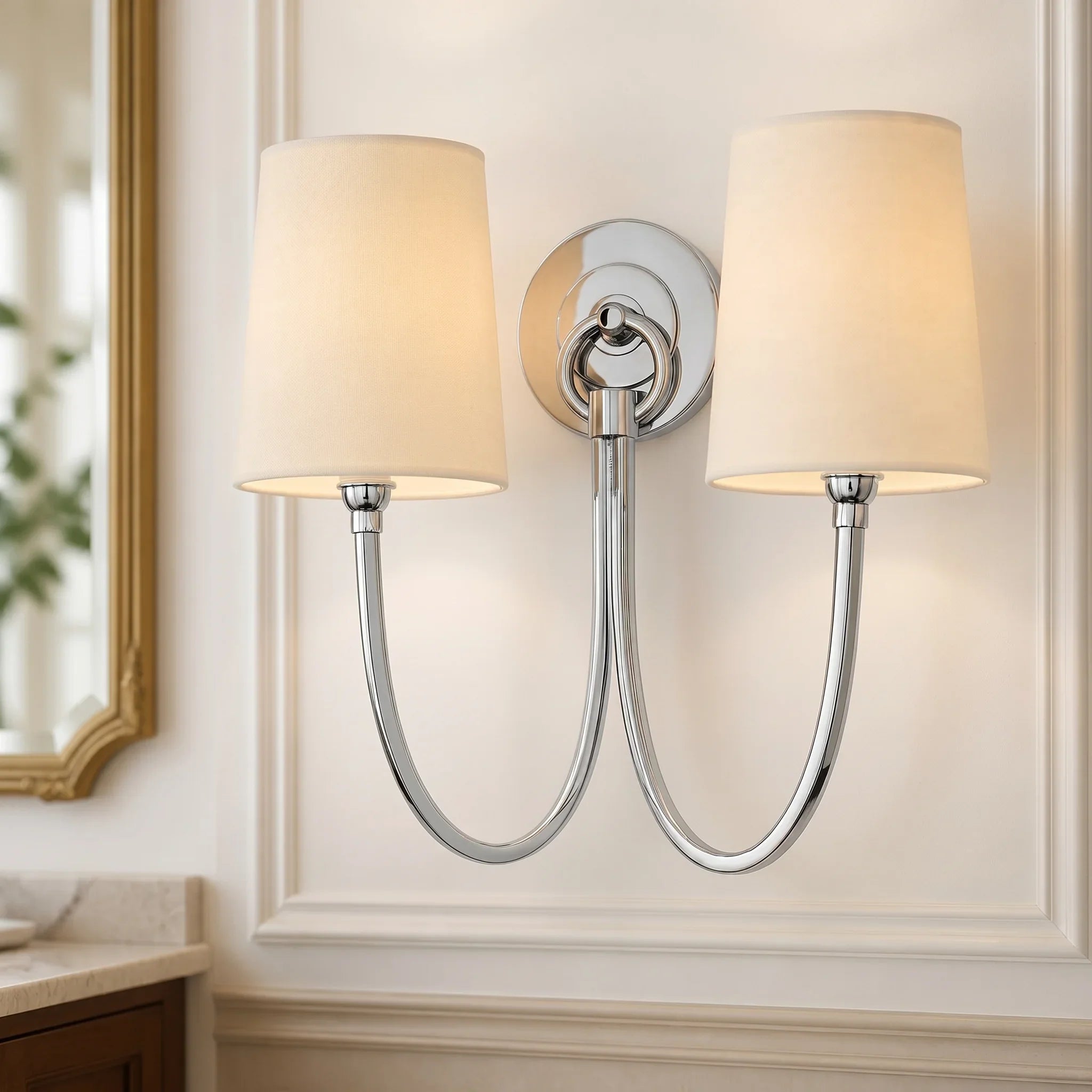 Double wall sconce with beige lampshades on a neutral wall.