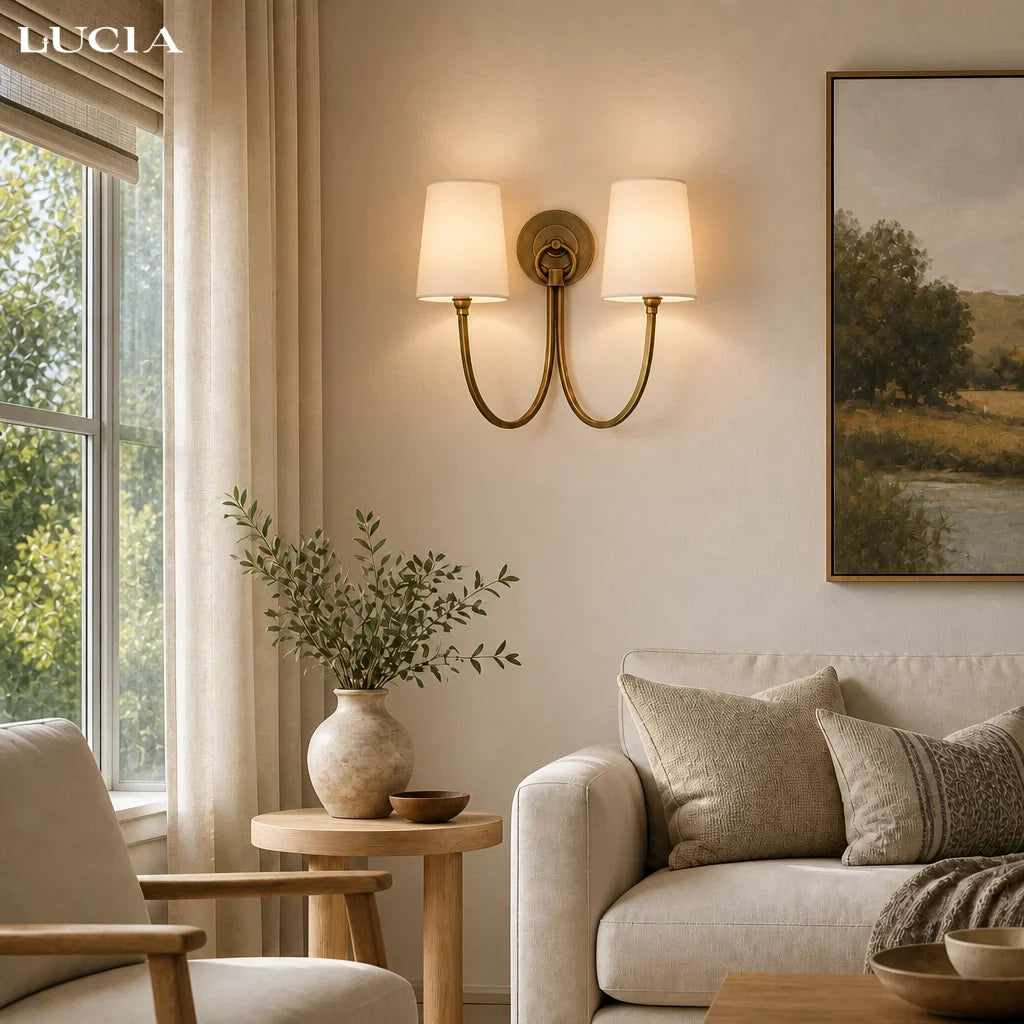 Cozy living room with beige sofa, armchair, and wall sconce.