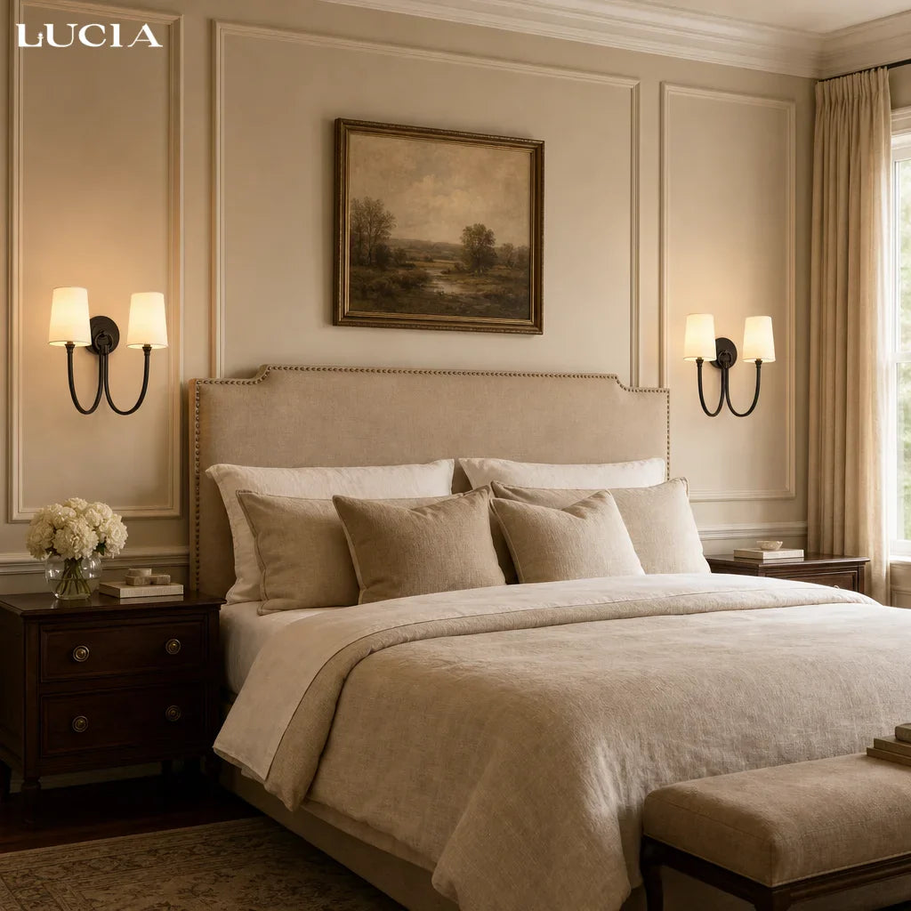 Neatly made bed in a bedroom with 'LUCIA' branding.
