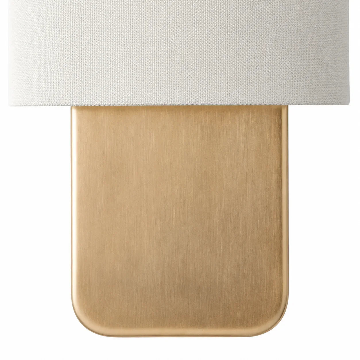 Close-up of a lamp with a white shade and gold base on a white background