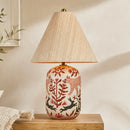 Decorative table lamp with a wooden base and floral design on a neutral background