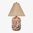 Decorative table lamp with a ceramic base featuring animal designs on a white background.